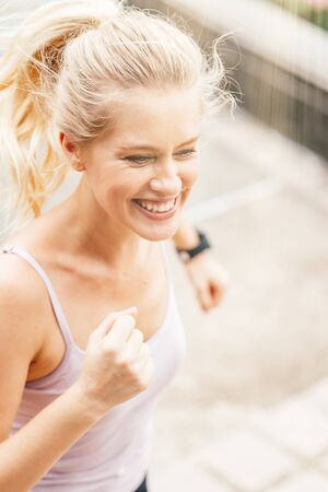 Happy to see results. Fitness girl having workout outdoorsの写真素材