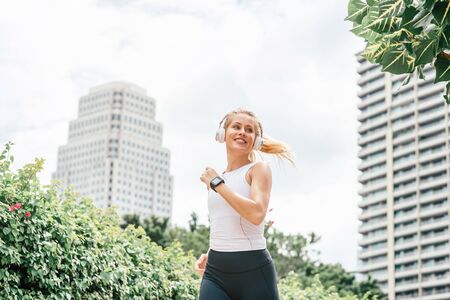 I run like a girl.try to keep up. Fitness girl having workout outdoors. Copy space on the left and on the right sideの写真素材