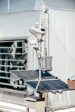 Nature Care. Solar panel installed inside greenhouse. Lightning system of modern hydroponic greenhouse, industrial agriculture. Vertical shotの写真素材