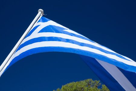The Greek flag waving in the sky