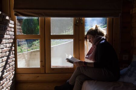 A woman relaxing and reading a book during holidays