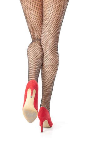 Sexy woman legs in fishnet stocking posingの写真素材