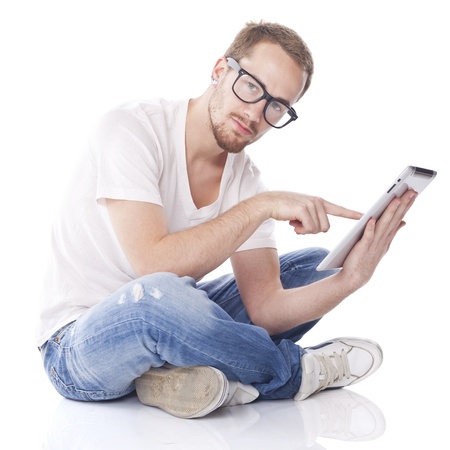 Good Looking Young Man Using Tablet Computer and seeting on floorの写真素材