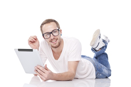 Good Looking Young Smart Man Using Tablet Computer and lying on the floorの写真素材