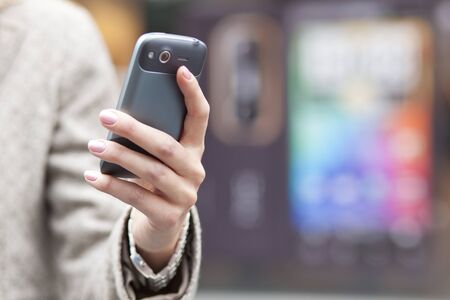 Woman with mobile phone in handの写真素材
