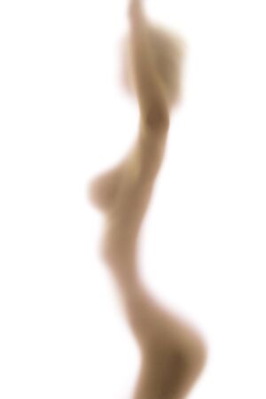 Blurred glass of bathroom hiding sexy woman silhouetteの写真素材