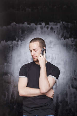 Young Man with smartphone, studio shot on blackの写真素材