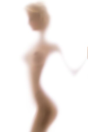 Sexy silhouette behind the blurred glass of bathroom, white backgroundの写真素材