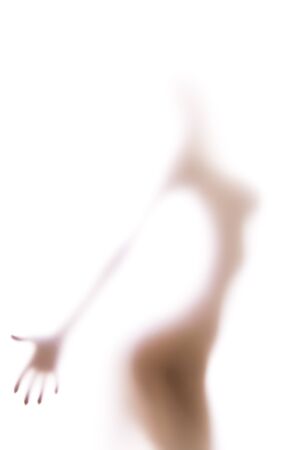 Sexy silhouette behind the blurred glass of bathroom, hand in focus, white backgroundの写真素材