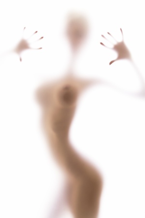 Blurred glass of bathroom hiding sexy nude woman silhouetteの写真素材