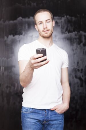 Man with mobile phone, background is blured cityの写真素材