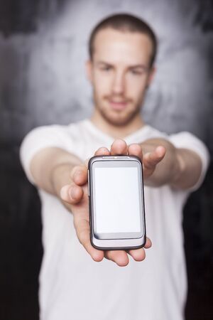 Man with mobile phone, background is bluredの写真素材