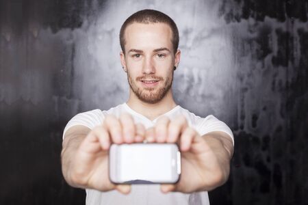 Man with mobile phone, background is bluredの写真素材
