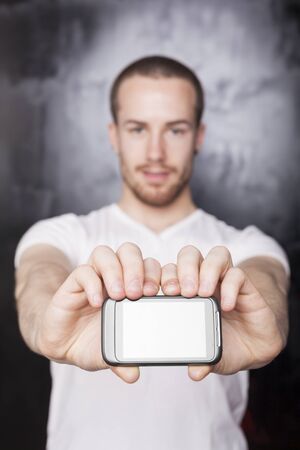 Man with mobile phone, background is bluredの写真素材