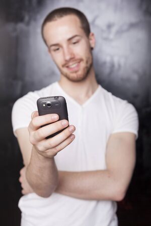 Man with mobile phone, background is bluredの写真素材