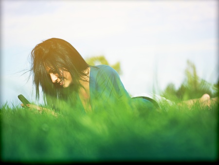 Young woman using laptop in parkの写真素材