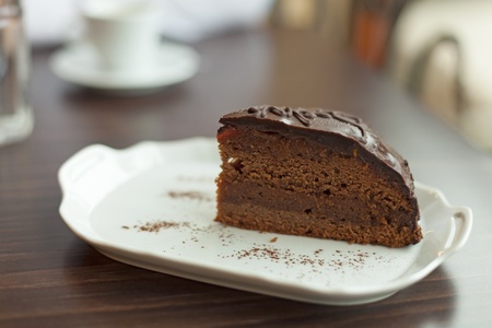 Sacher cake on white plate on table in cafeの写真素材