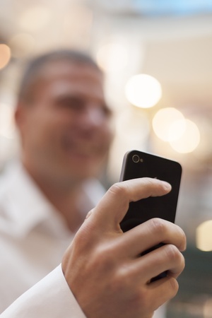 Man with smart phone on hand, blurred backgroundの写真素材