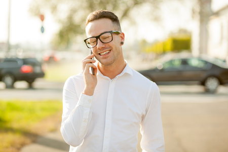 Man with glasses speak on mobile phone, In City, Urban Space, Parkの写真素材