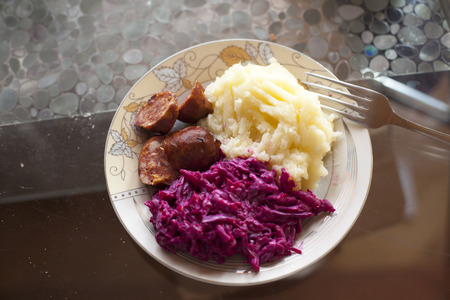 Meat sausage with potato puree and salad of beetの写真素材