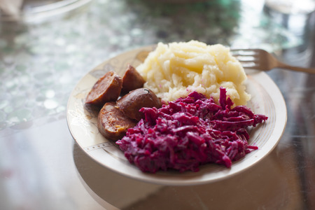 Meat sausage with potato puree and salad of beetの写真素材
