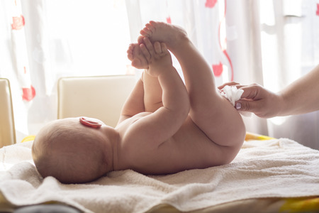 Hygiene - young momy wiping the baby skin with wet wipes. Cleaning wipe, pure, cleanの写真素材