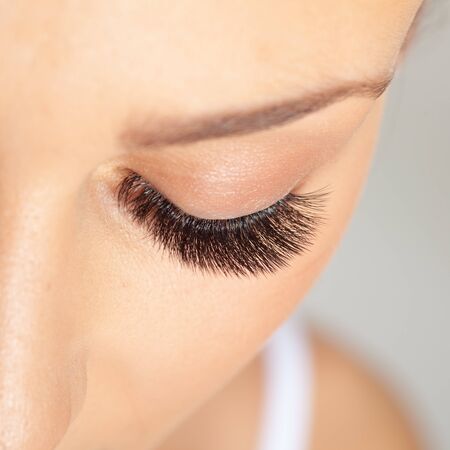 Treatment of Eyelash Extension. Lashes. Woman Eyes with Long Eyelashes.の写真素材