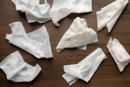 Used plastic wet wipes on wooden florの写真素材