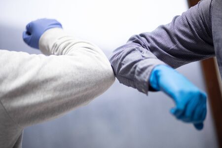 Business colleagues greeting with elbows during coronavirus pandemic. stock photoの写真素材