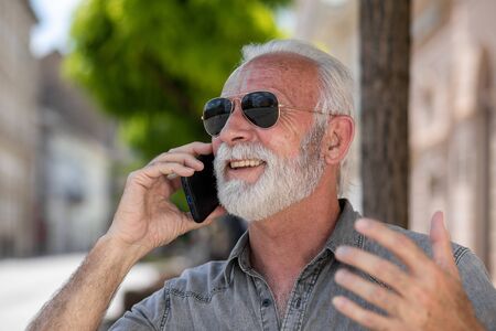 Old tourist man use internet communication app to speak free  in roaming