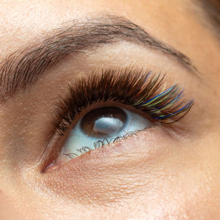 Treatment of Eyelash Extension with diferent colors. Lashes. Woman Eyes with Long Eyelashes in...