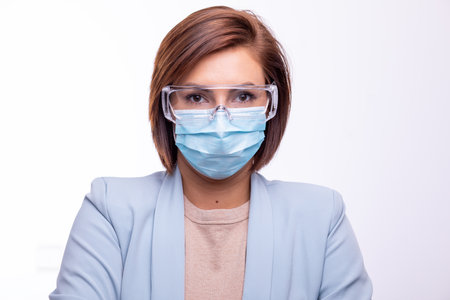 Doctor scientist or nurse protrait with facemask and protective glasses stock photoの写真素材