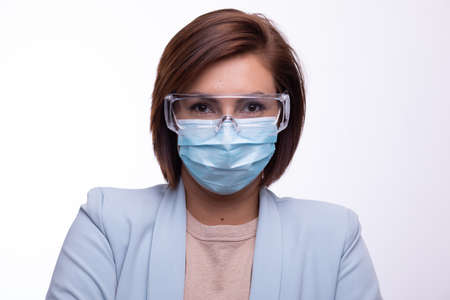 Doctor scientist or nurse portrait with facemask and protective glasses stock photoの写真素材