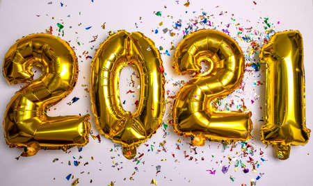 2021 concept new year from golden foil balloon and confetti stock photoの写真素材
