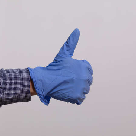 Man showing gesture - Everything is just fine in Gloves Stock Photoの写真素材