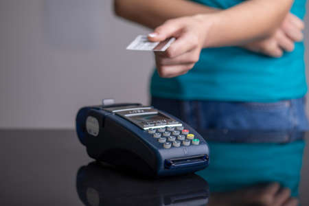 Payment by contactless credit card through the POS terminalの写真素材