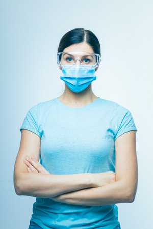 Worried nurse, doctor or scientist portrait behind facemask and protective glasses stock photoの写真素材