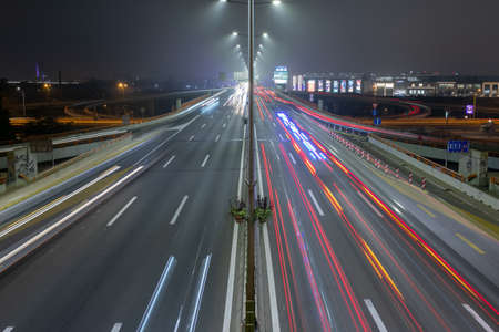 Belgrade, Serbia - light trails on motorway highway at night, long exposure urban backgroundの写真素材
