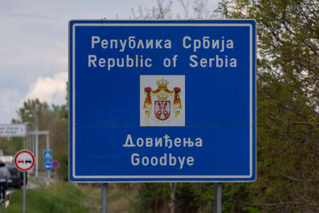 Horgos, Serbia - April 30, 2022: Republic of Serbia, Goodbay. Road sign with message and the National emblem on border between Serbia and Hungaryのeditorial素材