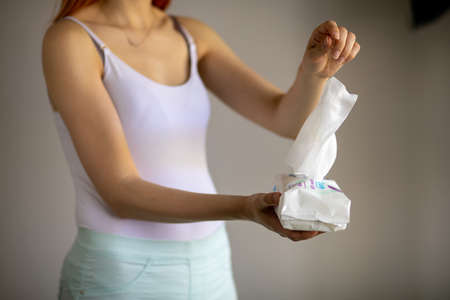 Woman taking wet baby wipes from the packaging - skin care, hygiene procedure and prevention of infectious diseasesの写真素材