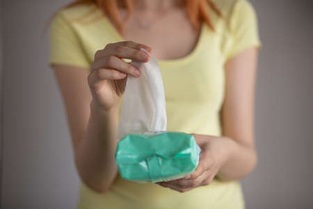 Woman taking wet baby wipes from the packaging - skin care, hygiene procedure and prevention of infectious diseasesの写真素材