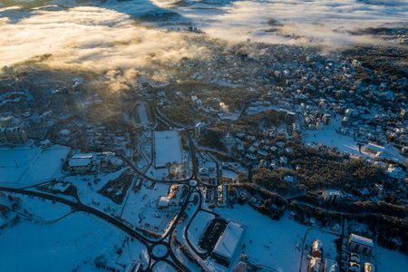 Panoramic aerial view of Zlatibor town and low cloud over Zlatibor Mountain at winter sunset, Cajetina, Serbia.の写真素材
