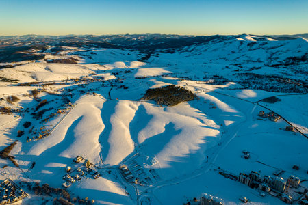 Panoramic aerial view of Zlatibor town and clear sky over Zlatibor Mountain at winter sunset, Cajetina, Serbia.の写真素材