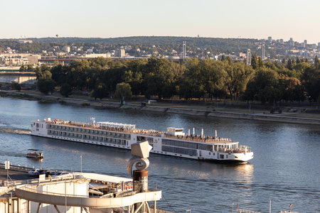 Belgrade, Serbia - July 28, 2024: river cruise ship on Sava river, continues his journey to Danube. Panorama of New Belgrade in background.の写真素材