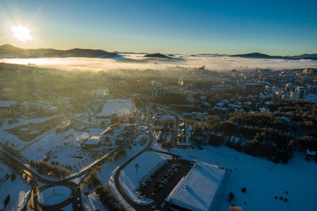 Panoramic aerial view of Zlatibor town and low cloud over Zlatibor Mountain at winter sunset, Cajetina, Serbia.の写真素材
