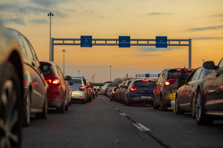 Horgos Roszke, Hungary - February 17, 2025: Long Queue of Pasengers Cars Stuck at EU Border Entrance between Serbia and Hungary, Horgos, Roszkeの写真素材
