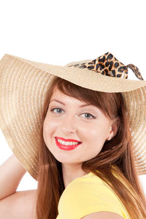 portrait of the young smiling girl in a straw hat on a white backgroundの写真素材