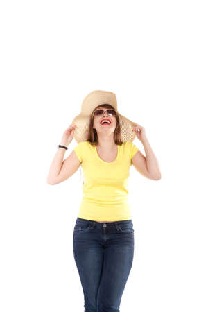 portrait of the young smiling girl in a straw hat on a white backgroundの写真素材