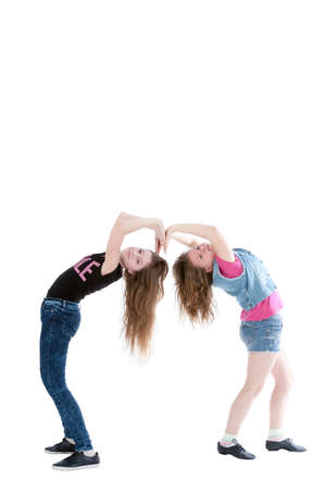 two smiling young beautiful girls on a white backgroundの写真素材