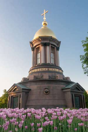 chapel in the city of Sankt- Petersburg against the blossoming tulips in the summer clear afternoonの写真素材